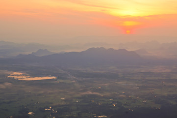 Blur sunrises over the mountain range and mist