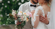 Stylish Bride And Groom Are Holding Bridal Bouquet