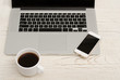 © somemeans - Top view of a laptop keyboard, smart phone and a cup of coffee