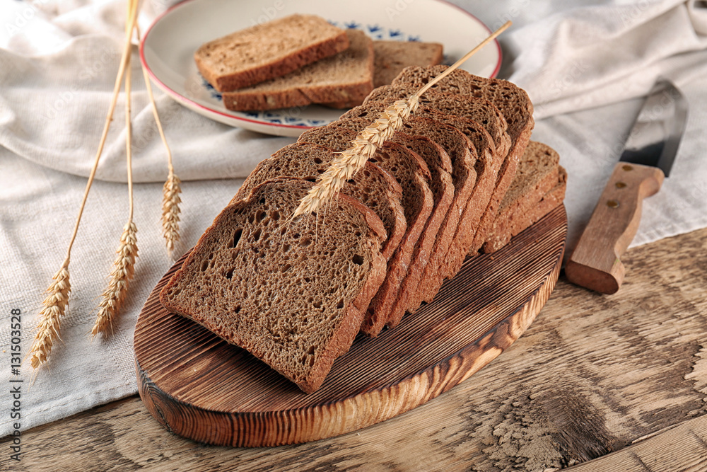 Sliced rye bread on wooden table closeup