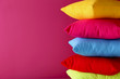 Colorful pillows on a pink background