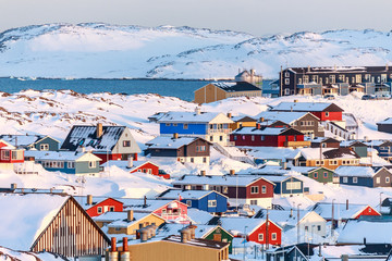 Nuuk city covered in snow with sea and mountains in the backgrou