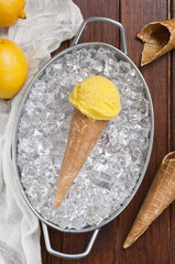 Wall Mural - Lemon ice cream cone on the ice cubes.