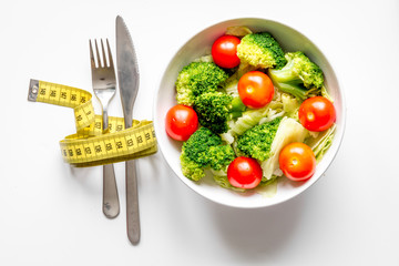 concept slimming diet fresh vegetables on white background top view