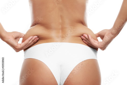 Fotografía Female hands touching her fat on body on white background