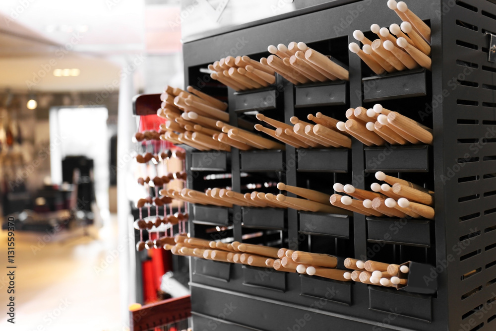 Drumsticks on shelves in music shop