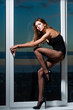 fashionable sexy girl at window