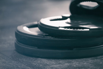 Canvas Print - Different weight plates on floor in gym, close up