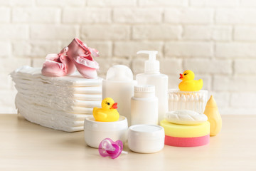 Set of baby accessories for hygiene on wooden table closeup