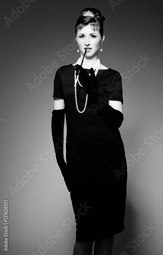 Fotografie, Tablou Portrait of a beautiful young woman in retro style with cigarett