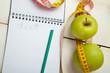 © denisk999 - Green apples with measuring tape on a white wooden table