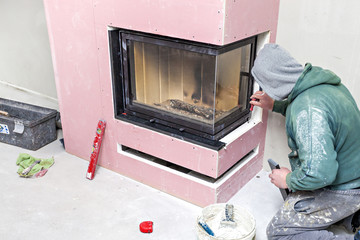 Wall Mural - Fireplace installing. Fireplace made from Calcium Silicate Fire Protective Board. Installation of Stone on Fireplace