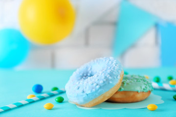 Wall Mural - Two donuts and Birthday decor on blurred brick wall background