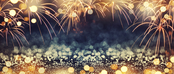 Wall Mural - gold and dark blue fireworks and bokeh in new year eve and copy space. abstract background holiday.