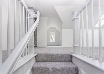 Custom stairs and railings are now carpeted and painted