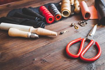 cobbler tools in workshop on wooden background mock up