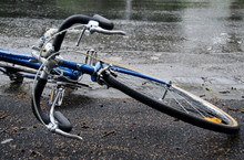 Bicycle Fallen Over On Road In The Rain