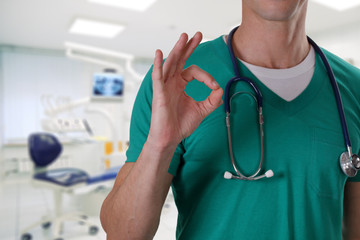 Male doctor dentist showing thumb up. Oral health care concept