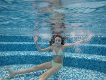 Girl Swimming Under Water In The Pool