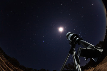 telescope over night sky with stars and moon