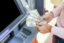 Woman Hand Withdrawing Money From Outdoor Bank ATM