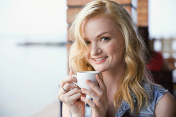 Sticker - Beautiful girl drinking coffee in cafe