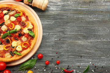 Sticker - Freshly baked  pizza with ingredients on wooden table