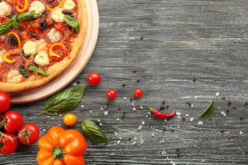 Sticker - Freshly baked  pizza with ingredients on wooden table