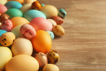 Wall Mural - Colourful Easter eggs on wooden background