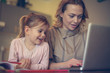 © liderina - Mother with daughter using laptop.