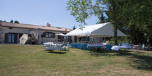 Organization Of A Big Celebration In The Garden In The Countryside In Front Of The House With A Barnum