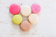 French macaroons on white wood background