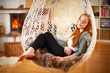 Young girl relaxing in a Hanging chair