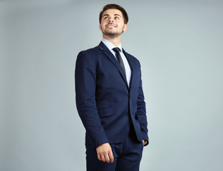 Sticker - Handsome young businessman on gray background