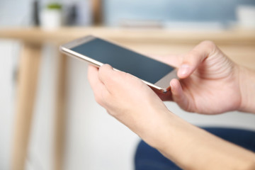 Sticker - Man using smart phone on blurred room interior background