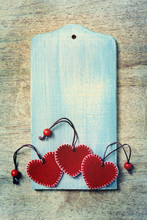 Three Red Hearts On Wooden Background
