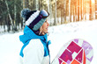 female snowboarder along with snowboarding among the trees