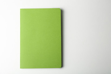 Blank green notebook on white background