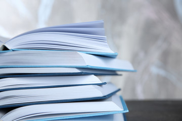 Sticker - Stack of open books on light background