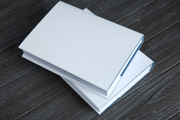 Poster - Books with white cover on wooden background