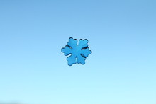 Tiny Jelly Snowflake On A Blue Background