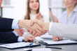 © rogerphoto - Close up of  two business man shaking hands to each other finishing up the meeting