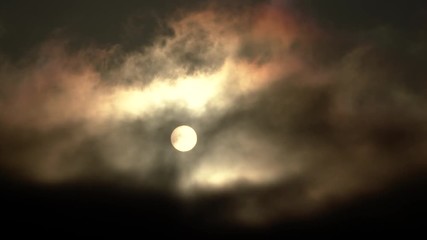 Wall Mural - Dark clouds pass through sky as sun sets or use for full moon at night.