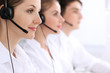 © rogerphoto - Call center. Focus on beautiful woman in headset