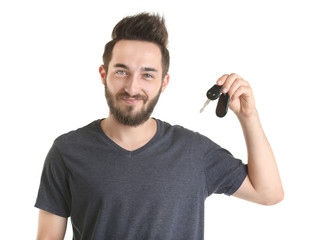 Wall Mural - Portrait of young man holding car key, isolated on white