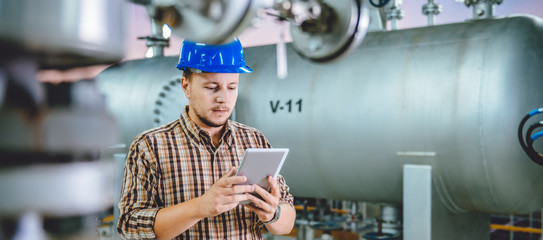 Man using tablet at Natural gas processing facility