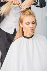 Wall Mural - Young woman is getting a hairstyle