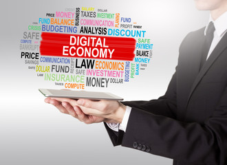Canvas Print - Digital Economy Concept, young man holding a tablet computer
