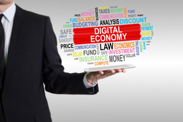Canvas Print - Digital Economy Concept. Man holding a tablet computer