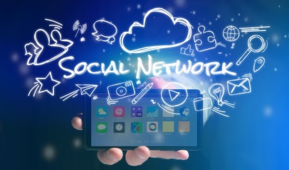 Concept of man holding smartphone with social network icon aroun